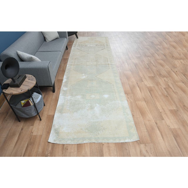 This vintage hand-knotted Runner rug is a semi-antique vintage area rug. The '70s Eastern region of Anatolian's unique rug...