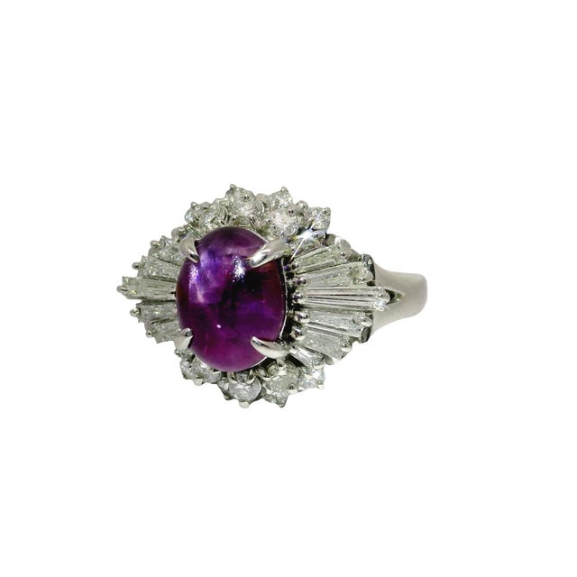 Discover the allure of this 3.93 carat purple sapphire! The cabochon sapphire radiates a captivating purple hue, drawing...