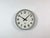 Wall clock produced by TN Telefonbau und Normalzeit in Germany during the 1960s. It features a grey iron frame, a white...