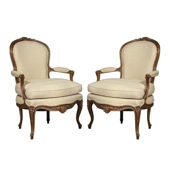 Immerse yourself in the timeless elegance of our exquisite late 19th-century French Louis XV walnut patinated bergères...