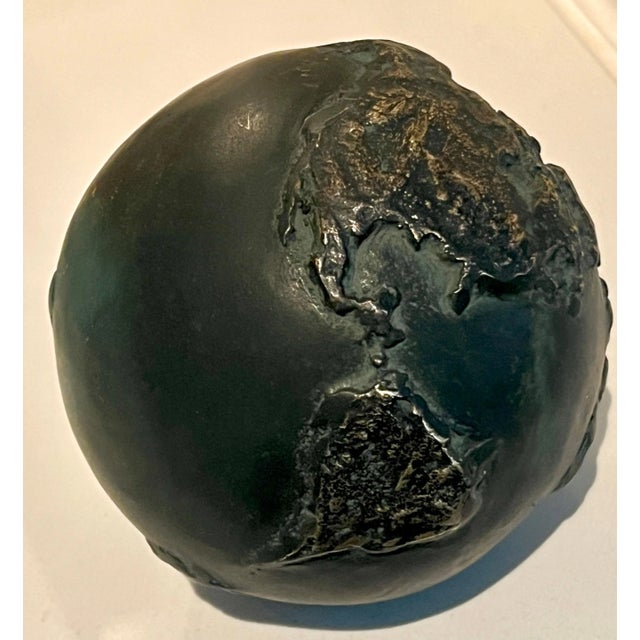 A bronze paper weight with raised portions representing the world / globe. A very heavy piece of bronze and perfectly...