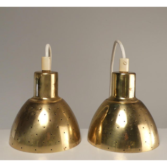 Hans-Agne Jakobsson perforated brass pendants manufactured by Markaryd, in Sweden around 1960. Brass downward facing...