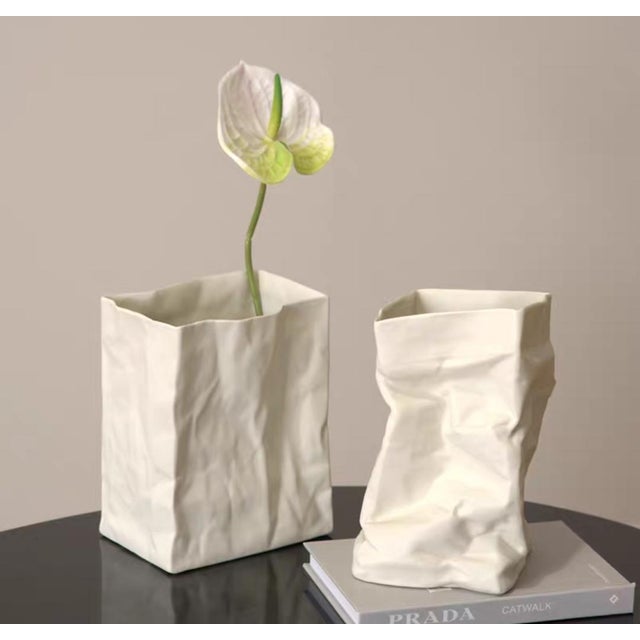 This handmade ceramic vase is inspired by vintage paper bags, with a natural wrinkled texture and vintage feel on the...