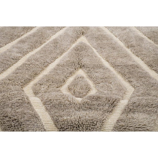 Rings of light, radiating from the center. This hand-knotted Moroccan wool rug features a hypnotic pattern of concentric...