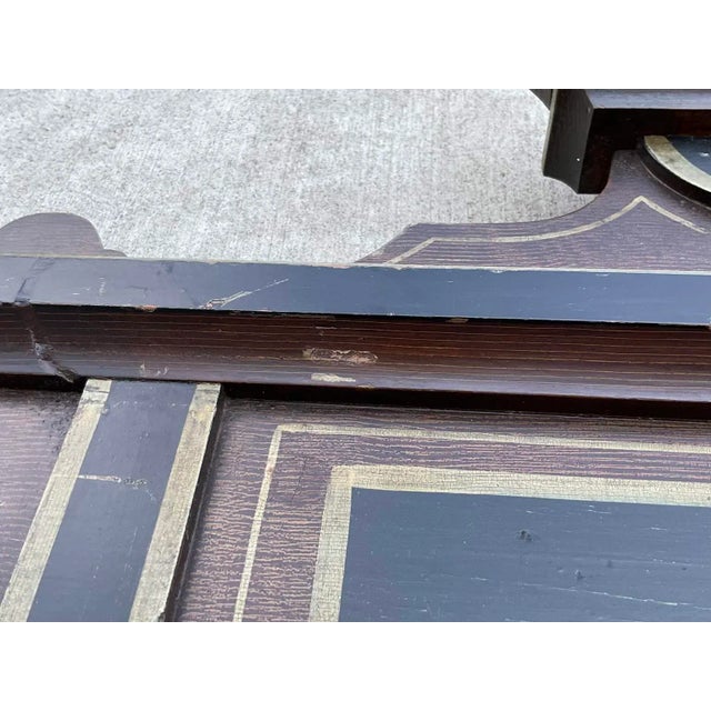 A distinctive antique American folk art hall mirror, dating to approximately the late 19th or early 20th century,...