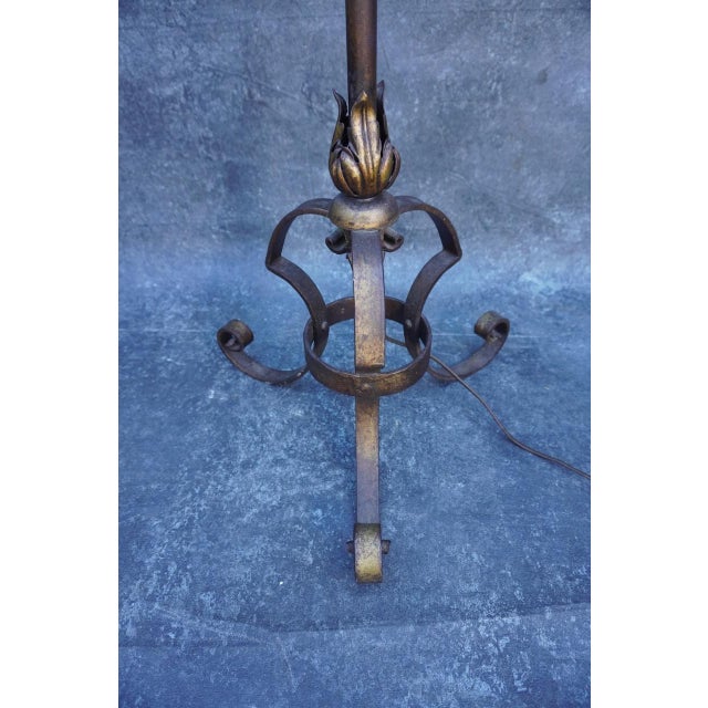 Spanish Revival torchiere floor lamp, dating to the 1920s, featuring a beautifully hand-forged wrought iron frame with...