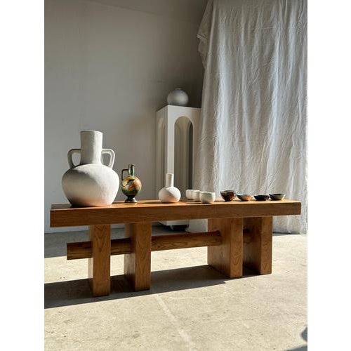 Solid wood bench (teak) with openwork base crossed by a cylinder. Excellent condition, elegant with its simple geometric...