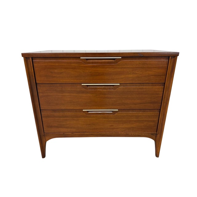 Add iconic 1960s style to your home with this Mid-Century Modern Kent Coffey “Impact” walnut bachelor chest. Featuring...
