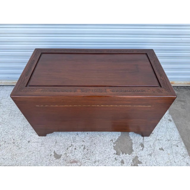 This is a very heavy blanket chest. The chest is constructed of teak. The outer edges and the handles are carved in teak....