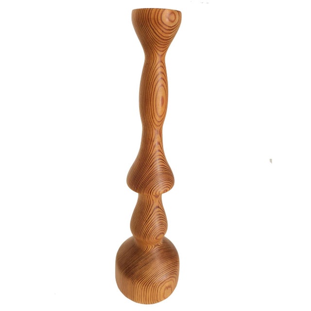 Offered is an artisan hand turned cherry wood candlestick. It has all sorts of interesting twists and turns, but somehow...