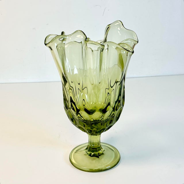 From the early Mid-Century, this is a Handkerchief Folded Rim Pedestal Vase in an Olive Green. The construction is...