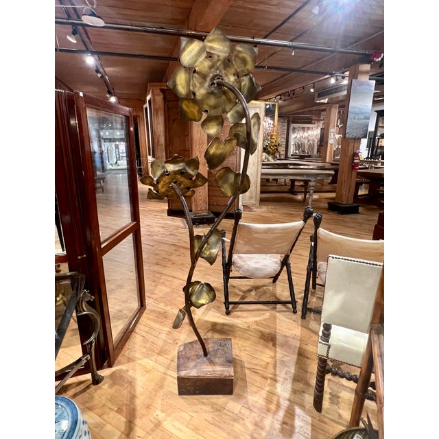 This stunning Brutalist sculpture of a sunflower is crafted from copper, brass, and burl wood, displaying a dynamic...
