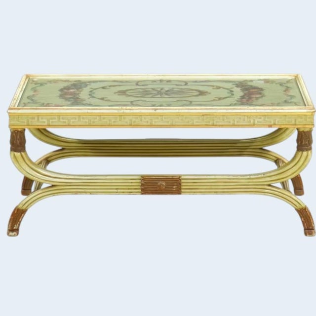Extremely well made Empire coffee table in pale cream and parcel gilt capitals, sabots, and borders. Top is beautifully...