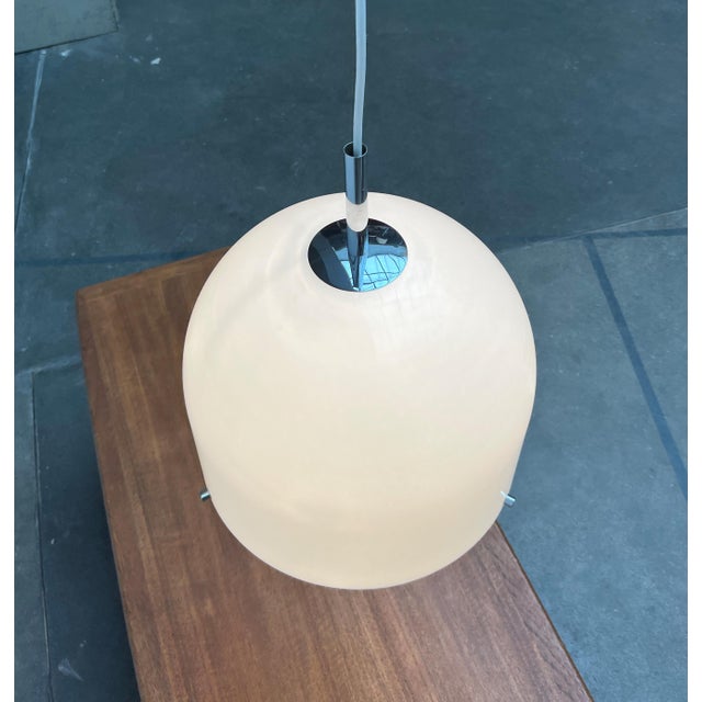 Imposing Space Age pendant lamp from Wila. The lamp body is bell-shaped and consists of two elements. At the bottom of the...