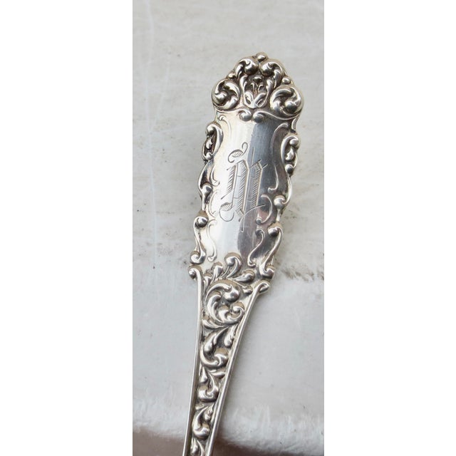 Scalloped bowl with a pierced design for draining. Unknown maker's mark. American Sterling. The monogram is M, and the...