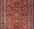 This rug is replete with an all-over symmetrical sub-geometric design set upon a red background and enclosed within a...
