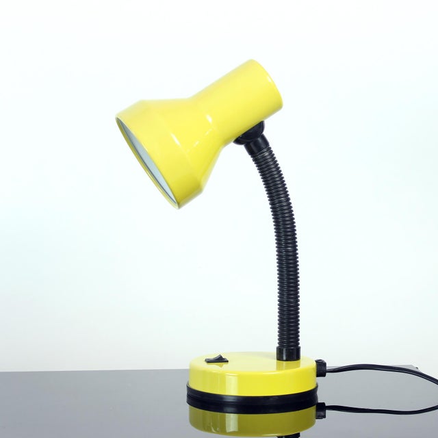 Playful and functional desk lamp by Rendi, model Baby 2. Featuring a vibrant yellow lacquered metal shade and base paired...