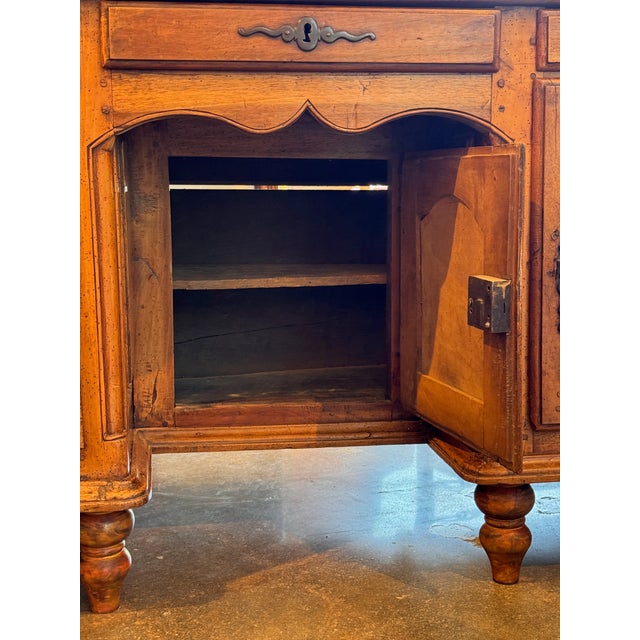 A handsome 18th-century French desk crafted in warm, richly patinated walnut. The breakfront form features three frieze...