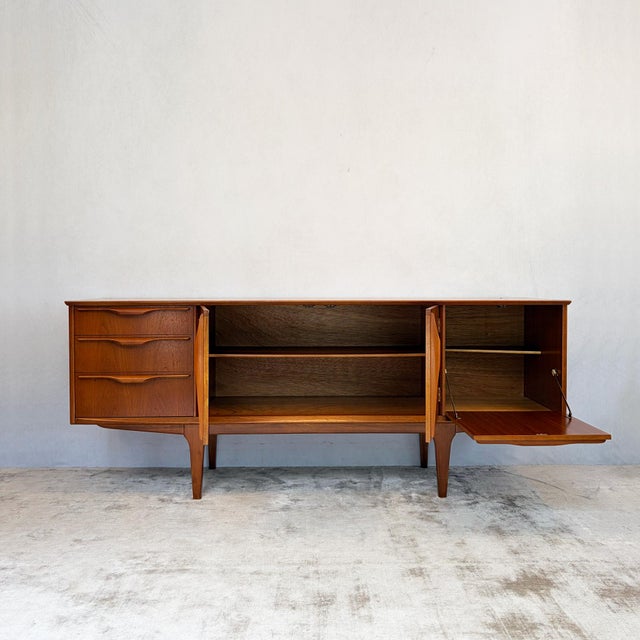 A long, low sideboard with plenty of presence and genuinely useful storage to match. It's fitted with three drawers to the...