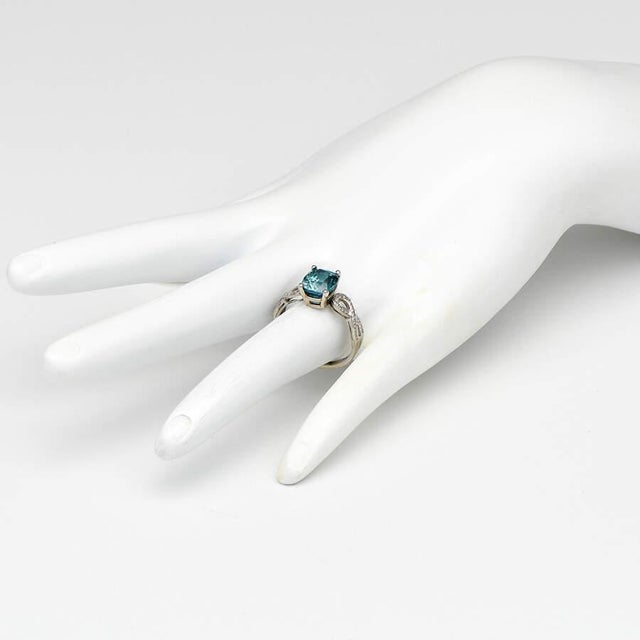 With a stunning center stone as blue as the Caribbean, this riveting ring also benefits from a whole host of wondrous...