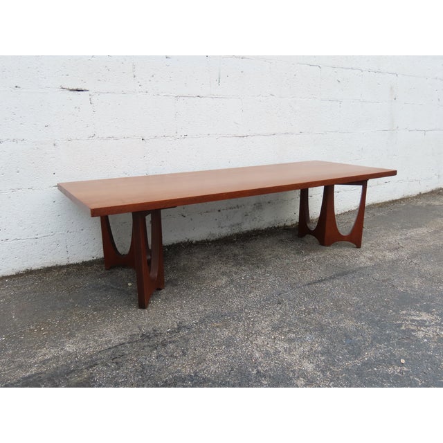 This gorgeous Coffee Table is made out of wood, solid wood, walnut, and veneer. The Coffee Table was made by Broyhill...