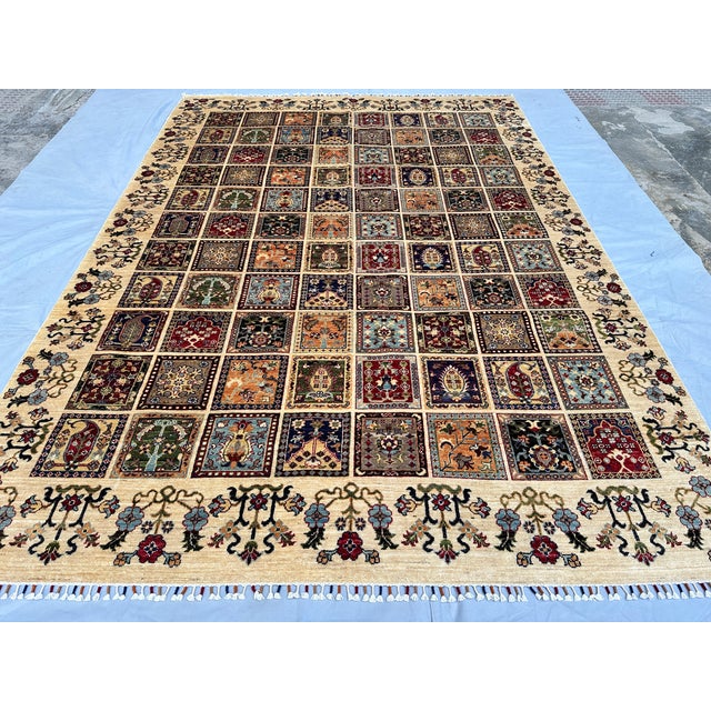This exquisite hand-knotted wool area rug features a classic Bakhtiari garden design. The main field is divided into an...