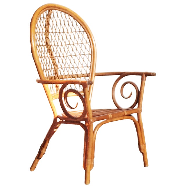 Handsome pair of mid-century rattan chairs in the Palm Beach Regency or Coastal style. Commonly referred to as Peacock or...