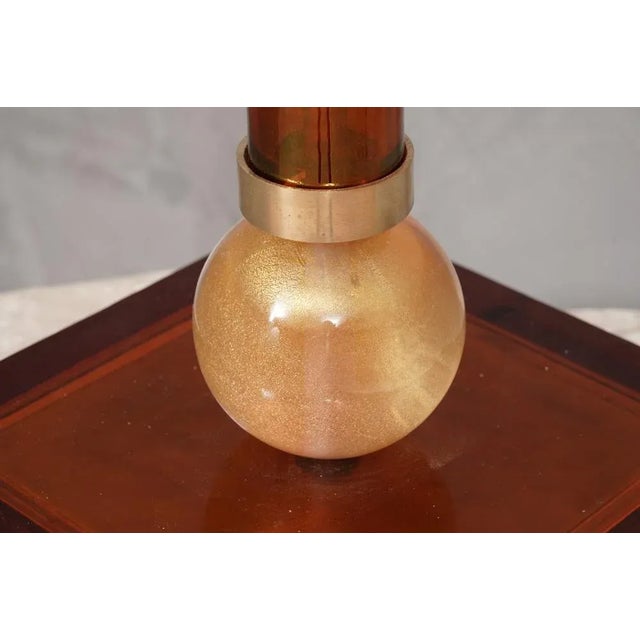 Incredible beauty for a mid-century Murano amber glass table lamp, elegant and with a very intense color. The table lamp...