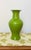 A striking 20th-century decorative piece in the style of antique Chinese monochrome wares. This flared-neck baluster vase...