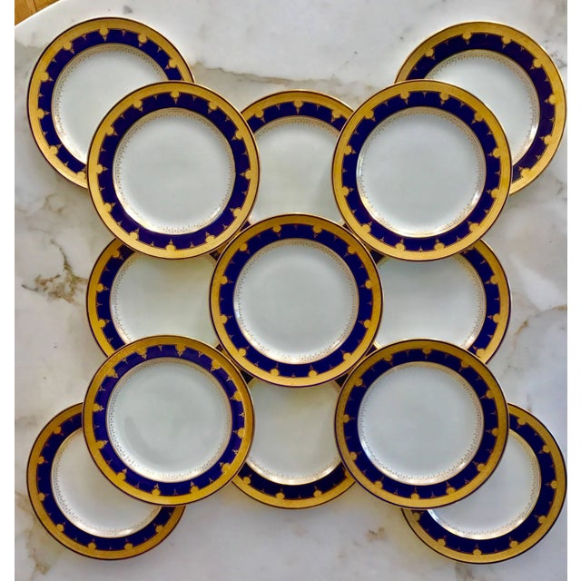 This Set of 12 beautiful cobalt blue and gold bordered Dinner Plates were produced by Minton and retailed by David...