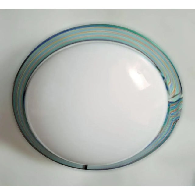 Vintage Italian flush mount or wall light with a single milky white Murano glass shade enclosed in a green border hand...