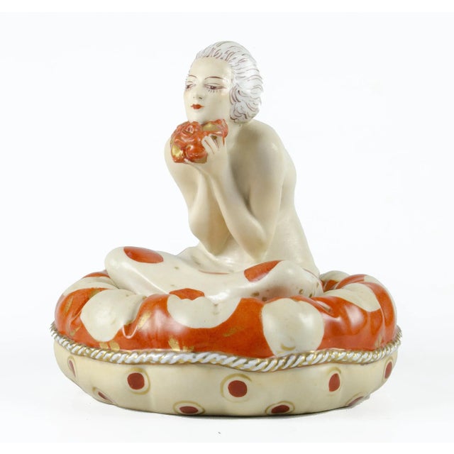 Early 20th century Art Déco hand-painted ceramic cosmetic powder bowl of a lady sitting over a cushion by Aladin, France...