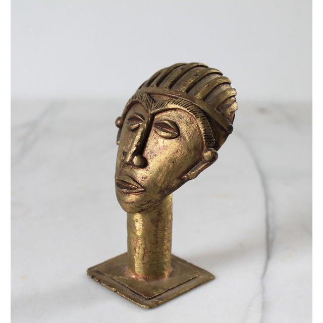 Vintage Ghanaian brass mask head on a pedestal. Maker mark on bottom. Minor age wear.