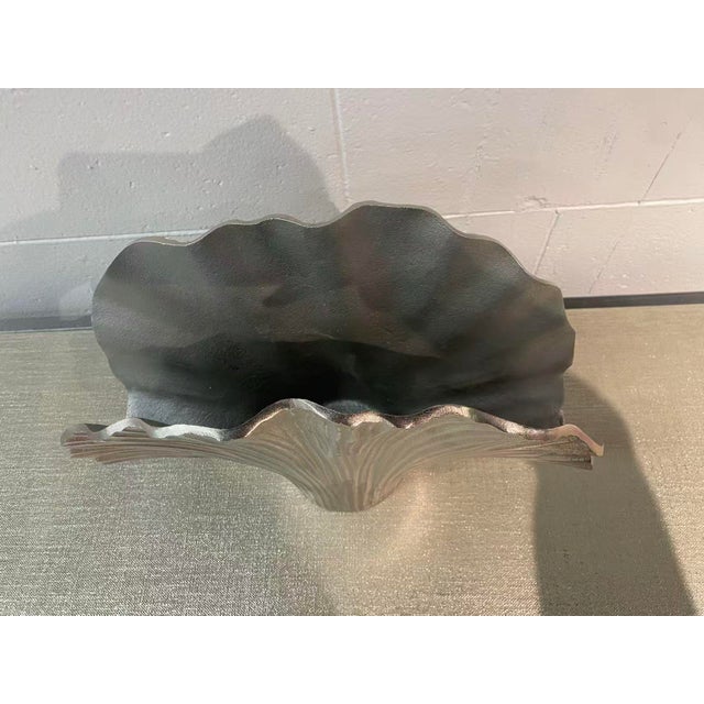 The ginkgo leaves of this aluminum vase are defined by textured ridges and grooves with a nickel finish.