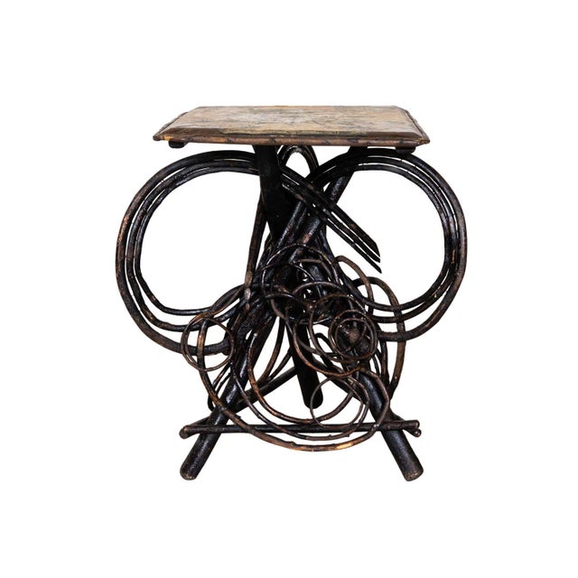 Twig table with hand painted folk art top. Elaborate tripod base with large twisted branches and twigs.
