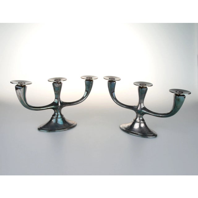 Pair of German "WMF" silver-plated candleholders, each fits three candles. Both are signed underneath. Light tarnish to...