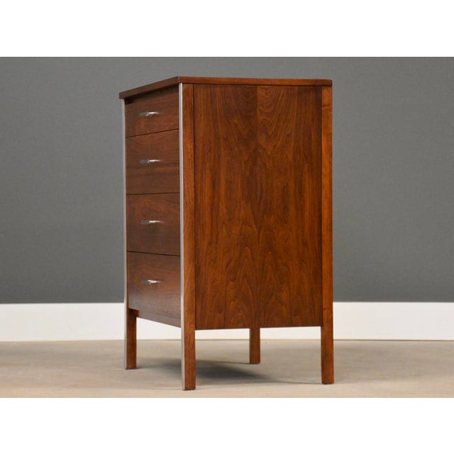 A mid century modern walnut four drawer dresser chest or oversized nightstand with aluminum drawer pulls designed by Paul...