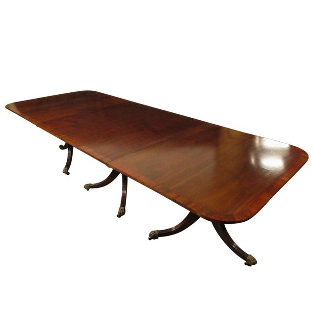 A 19th-C. American Regency inlaid mahogany triple pedestal dining table, with cherry banding, all original brass hardware...