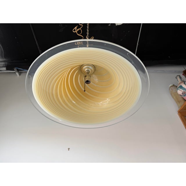 Elegant 1970’s Italian Mid-Century Modern pendant lamp featuring a beautifully crafted Murano glass shade with a striking...