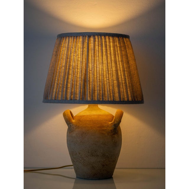 A two-handled French stoneware jar, once a working storage vessel, converted into a table lamp and finished with a new...
