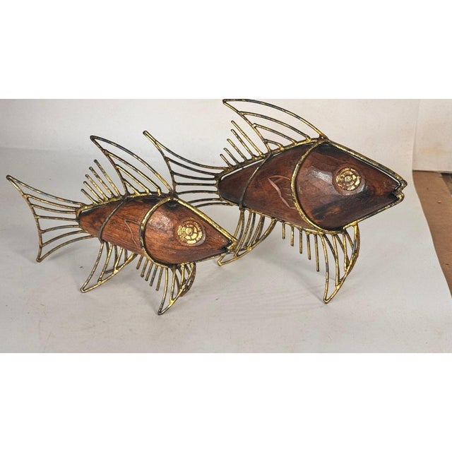 Pair of 1970s french fish sculptures – wood and gilded metal mid-century decor : this elegant pair of fish sculptures from...