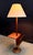 This walnut floor lamp by Laurel Lamp Company combines three functions in one elegant form: a turned round base supports a...