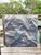 A large photorealistic or tromp-l’oeil style oil painting on canvas in muted shades of blue and gray.