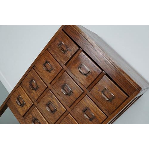 This apothecary / filing cabinet was produced during the 1930s in the Netherlands. This piece features 12 drawers on slim...