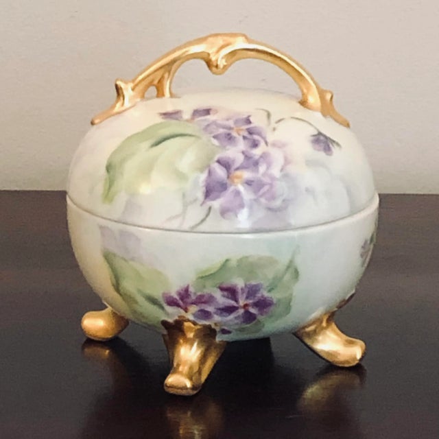Offering a beautiful French Limoges-style porcelain box. This lovely hand painted box features striking purple violets and...