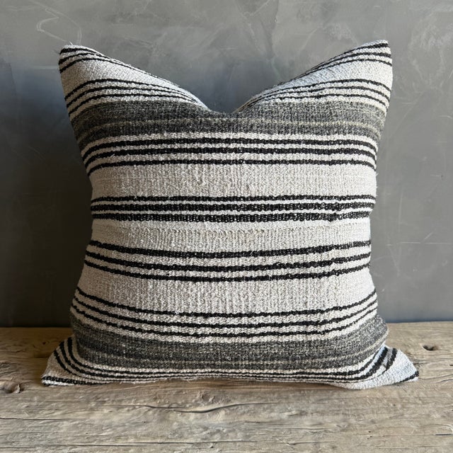 Creamy white hemp rug pillow with stripes. Soft hand, linen blend backing with zipper closure. Spot cleaning is...