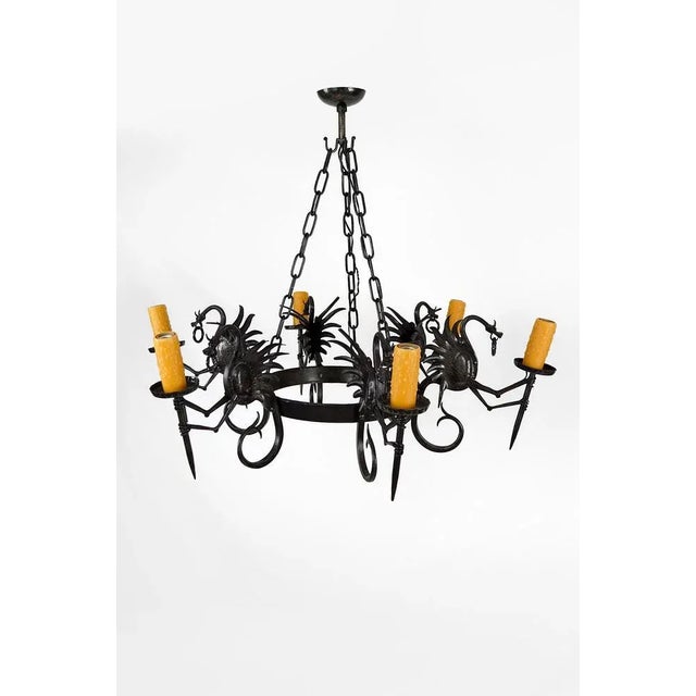 Superb and impressive wrought iron chandelier / pendant composed of 6 winged dragons each holding a torch / torchiere....