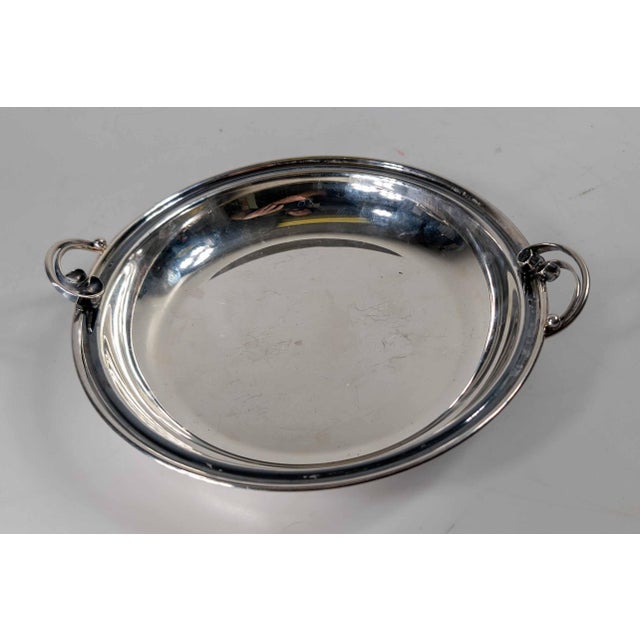We are offering this simple Danish silverplate dish or bowl with floral form handles. Dish is 20th century with art Deco...