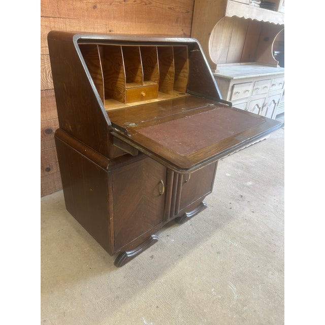 A handsome 1930s Art Deco waterfall secretary desk with beautiful geometric book matched veneer, a rounded waterfall...