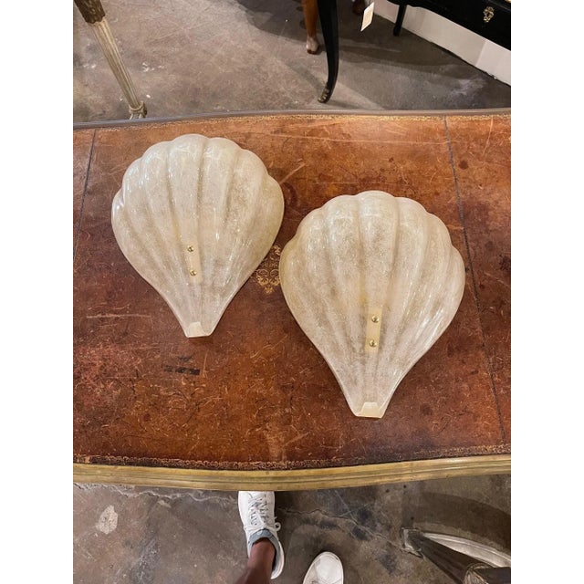 Elegant pair of modern Murano shell form sconces. The color is translucent with touches of gold. Gorgeous for a variety of...